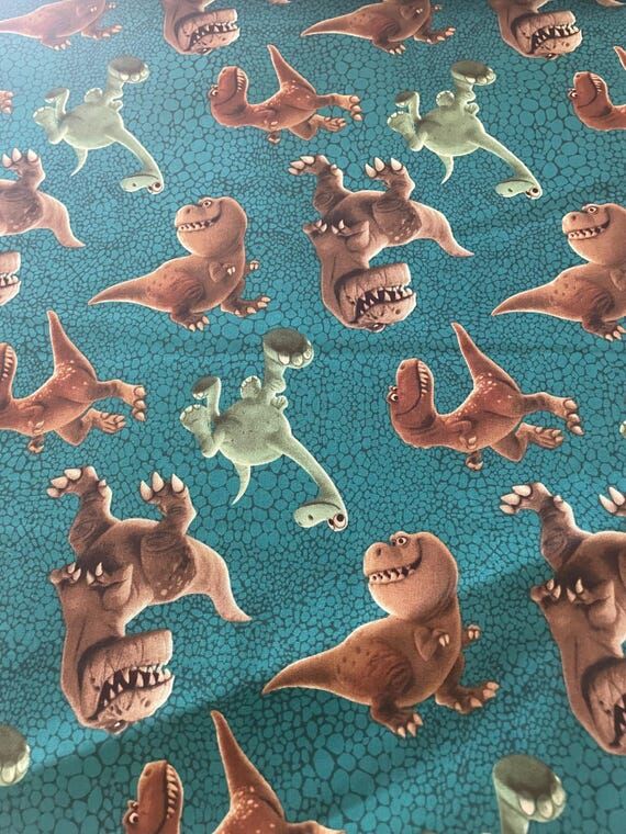 Dinosaurs on teal background, quilting fabric...