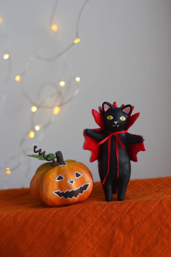 Black vampire cat and orange pumpkin figurine...