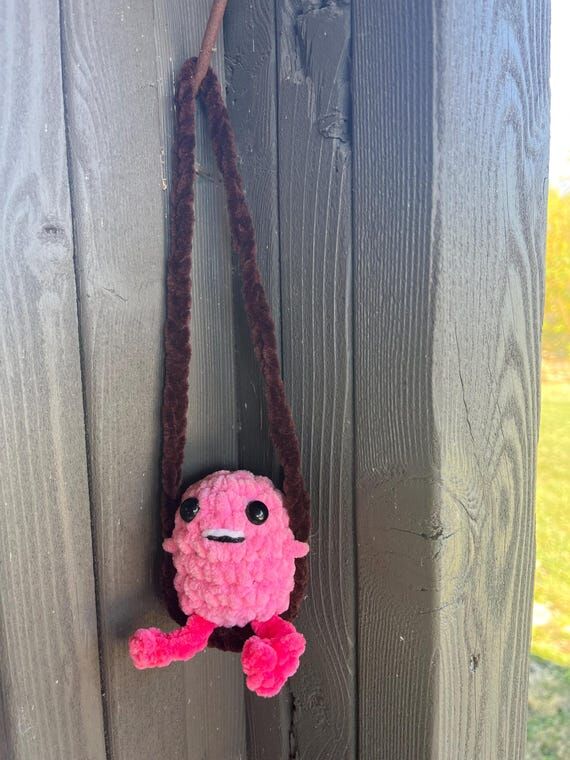 Handmade crochet flamingo on a swing....