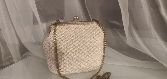 Crochet clutch in milk white color; an evenin...
