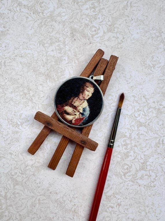 Woman portrait.Circular hand embroidered pend...