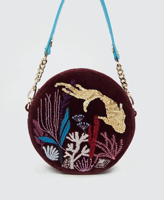 Round velour bag in deep wine color with hand...