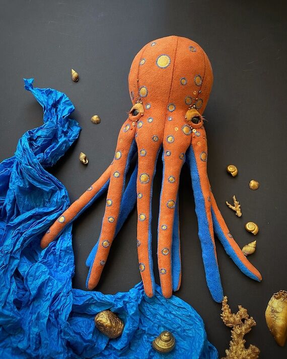 Plush toy octopus in orange and blue colors, ...