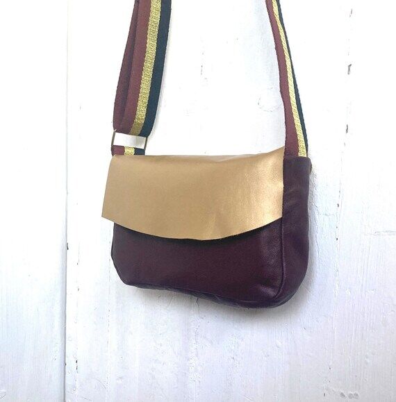 PLUM is a handmade shoulder bag in plum and g...
