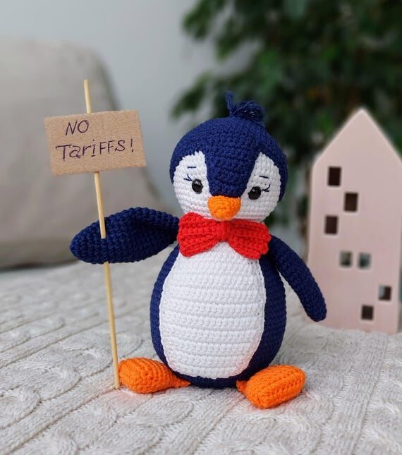 Crochet penguin, protesting sign, plush stuff...