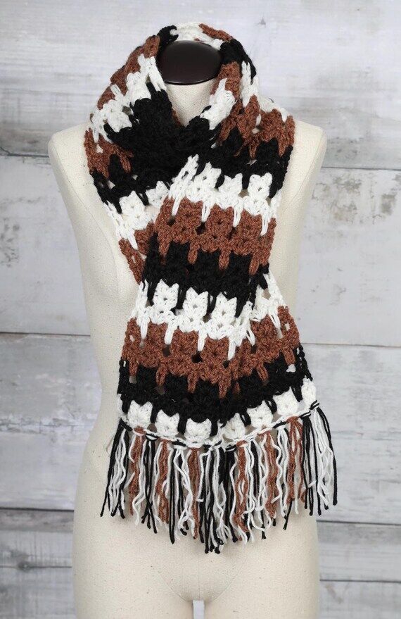 black, white and brown handmade crocheted cat...