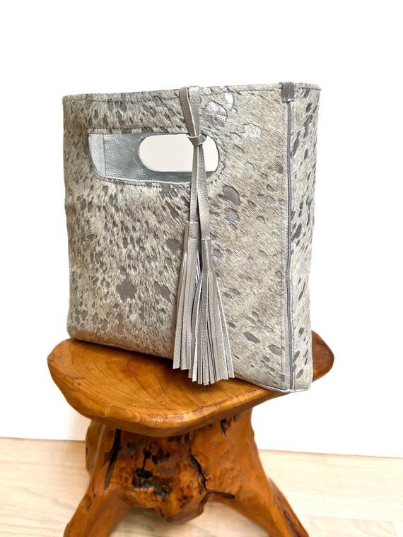 Metallic silver and white hair-on cowhide han...