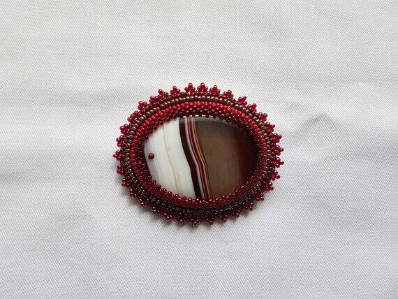 Handmade beaded red brooch with red/white str...