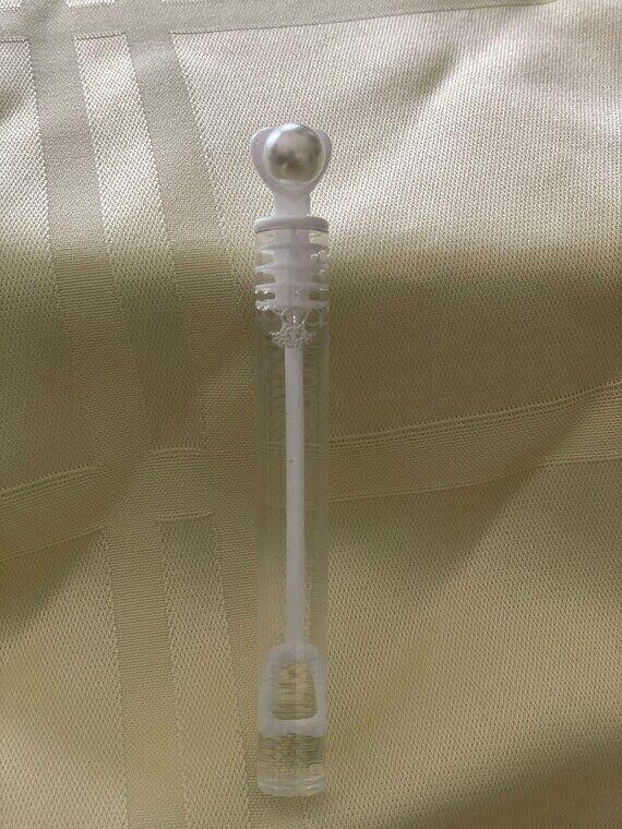 Bubbles in a clear tube decorated with a whit...