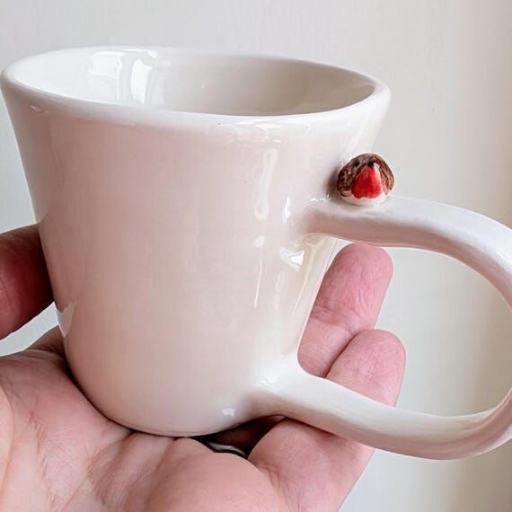 Espresso cup with robin bird and footprints, ...