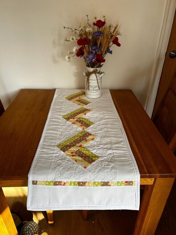 Beautiful quilted table runner in spring hear...
