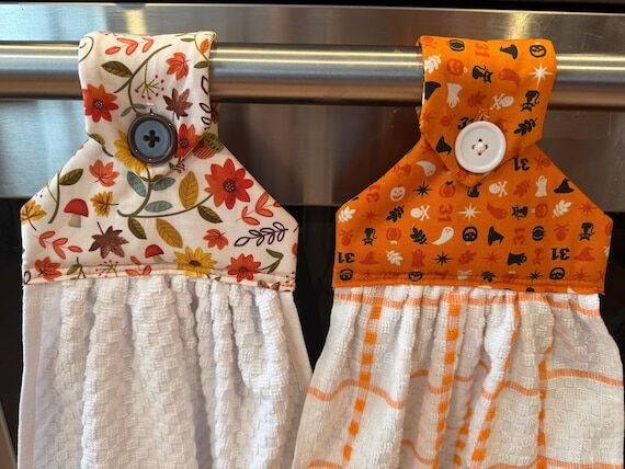 Hanging buttoned kitchen towel...