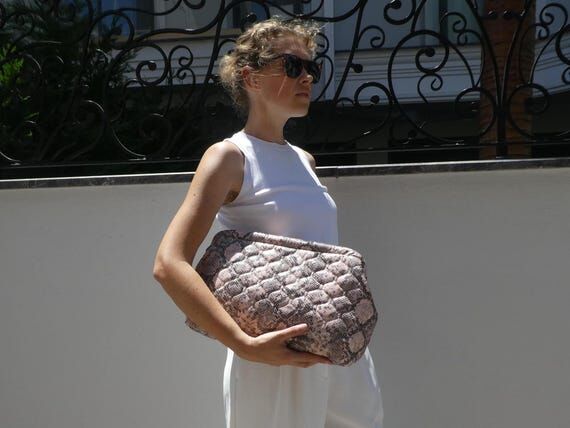 Oversized faux leather clutch in python patte...