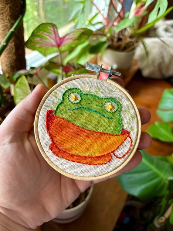 Little froggy in a cup. Toad in teacup coffee...