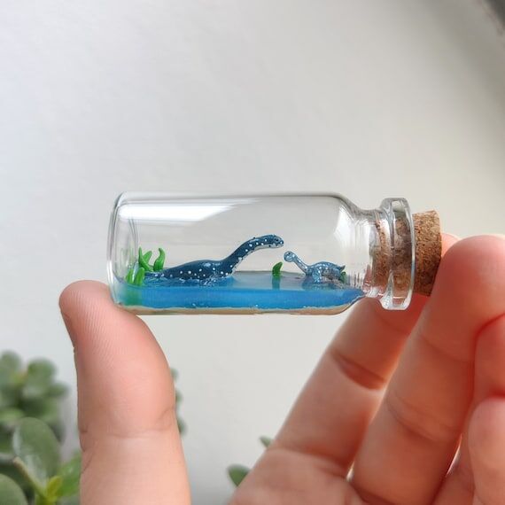 little plesiosaurus with baby in a glass-bott...