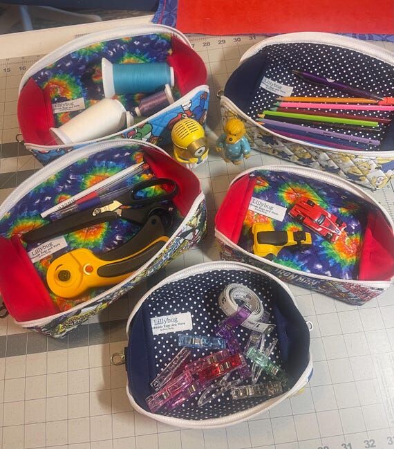 Handmade quilted zippered pouches open to cre...