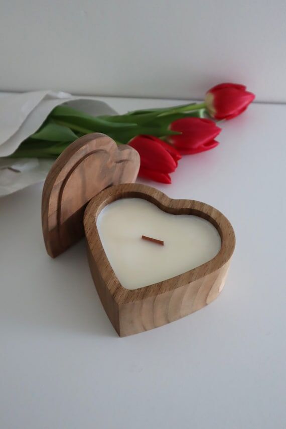 Heart candle in a wooden bowl with a lid and ...