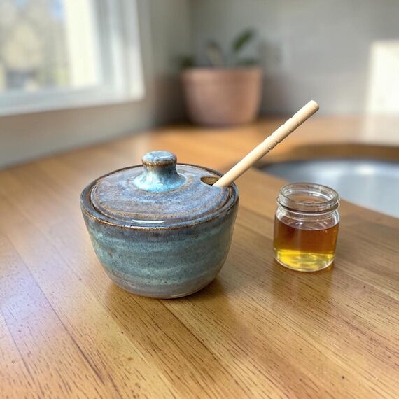 Handmade stoneware honey jar with dipper...